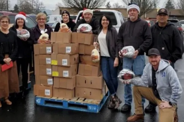 Cowlitz and Wahkiakum County union members standing next to boxes of food they've donated to Lower Columbia CAP