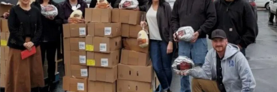 Cowlitz and Wahkiakum County union members standing next to boxes of food they've donated to Lower Columbia CAP